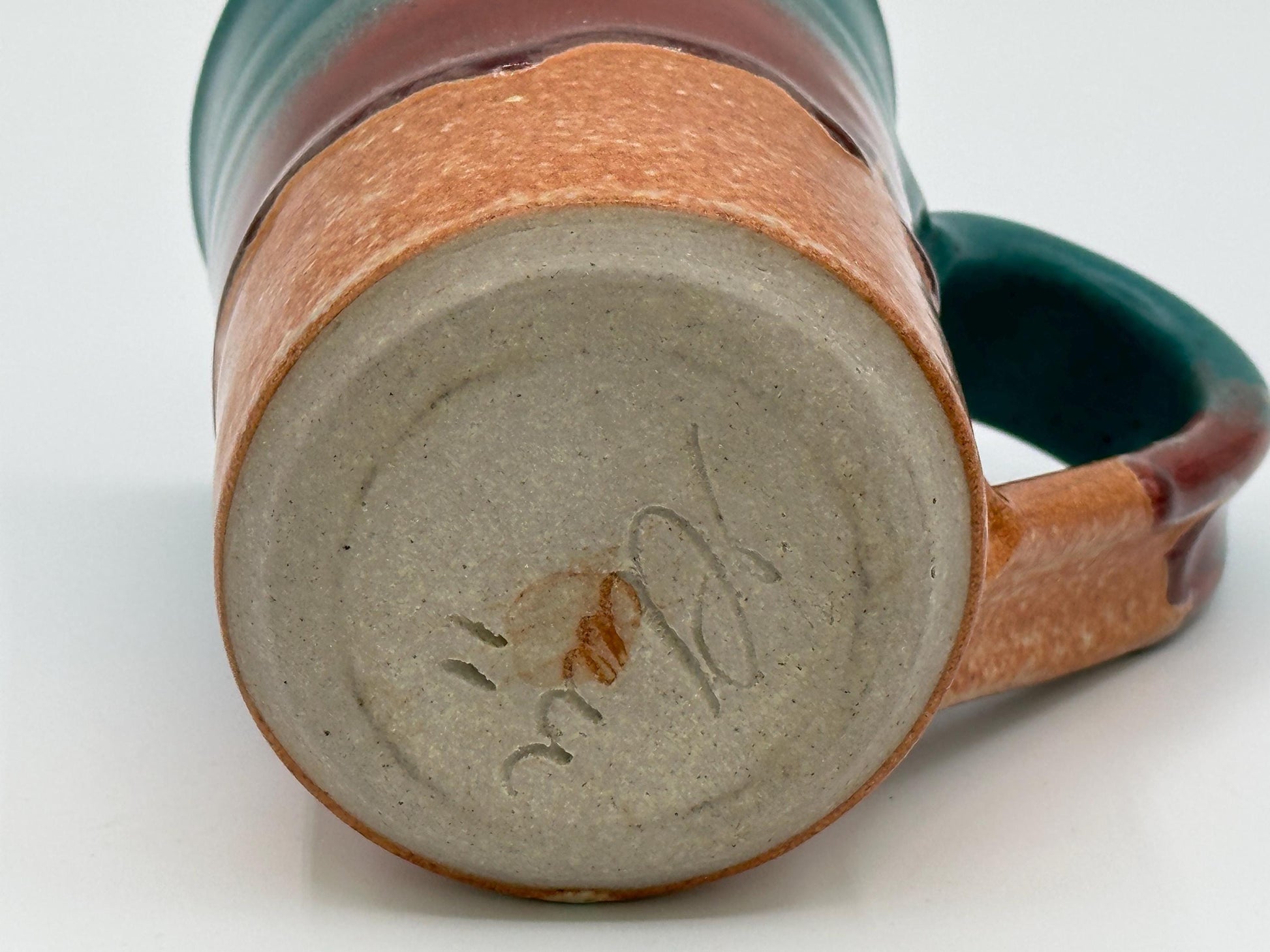 Rustic Stoneware Mug: Handcrafted Ceramic Coffee Cup with Teal, Red & Brown Drip Glaze