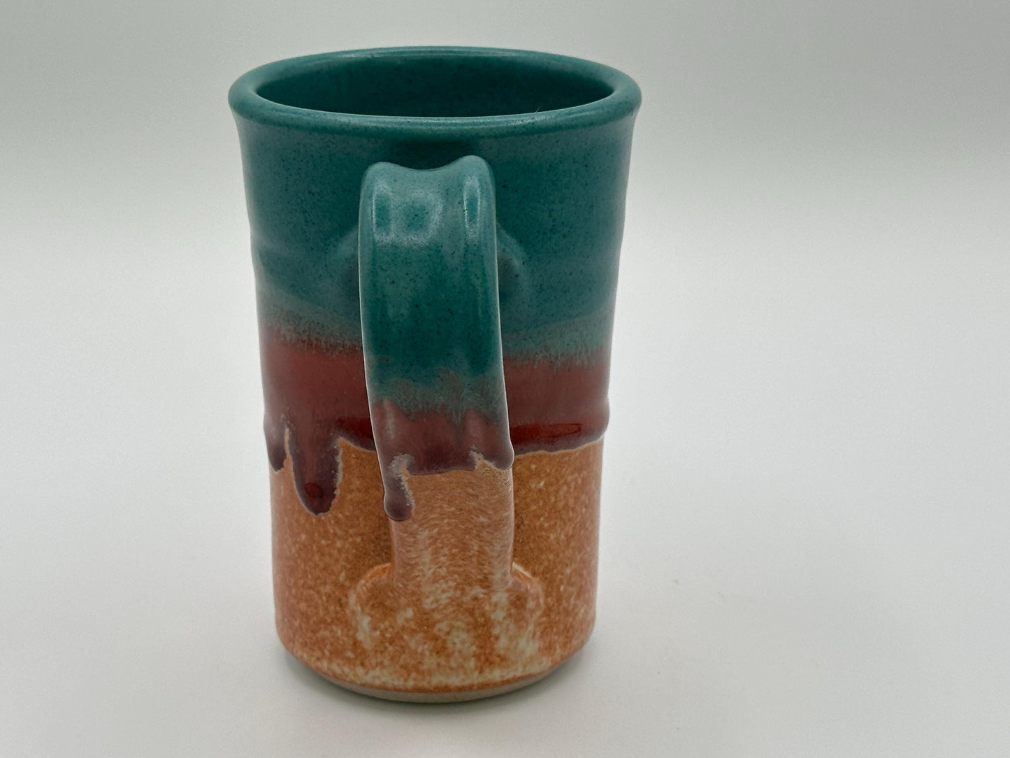 Rustic Stoneware Mug: Handcrafted Ceramic Coffee Cup with Teal, Red & Brown Drip Glaze