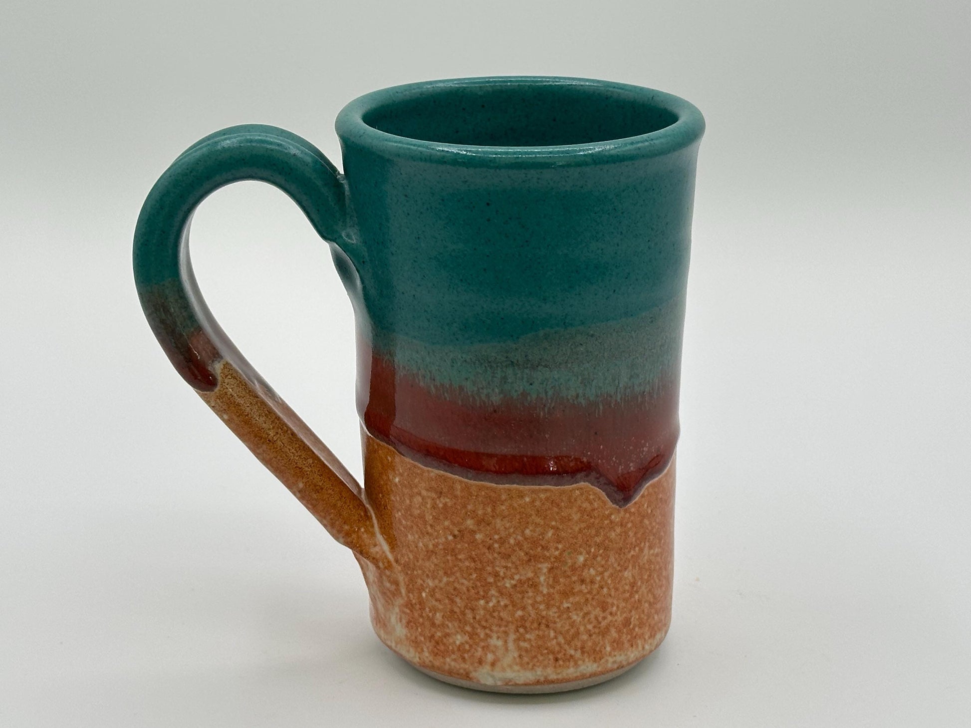 Rustic Stoneware Mug: Handcrafted Ceramic Coffee Cup with Teal, Red & Brown Drip Glaze