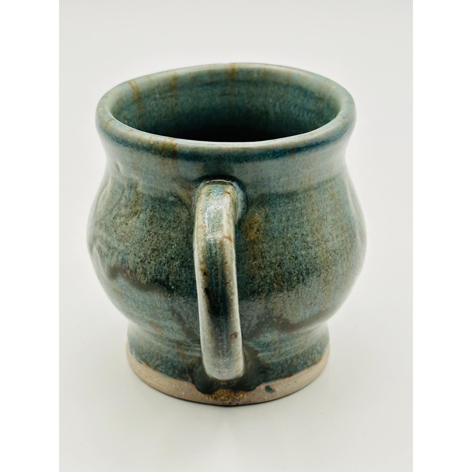 Handmade Artisan Pottery Mug – Blue Green Glaze with Raised Decorative Pattern