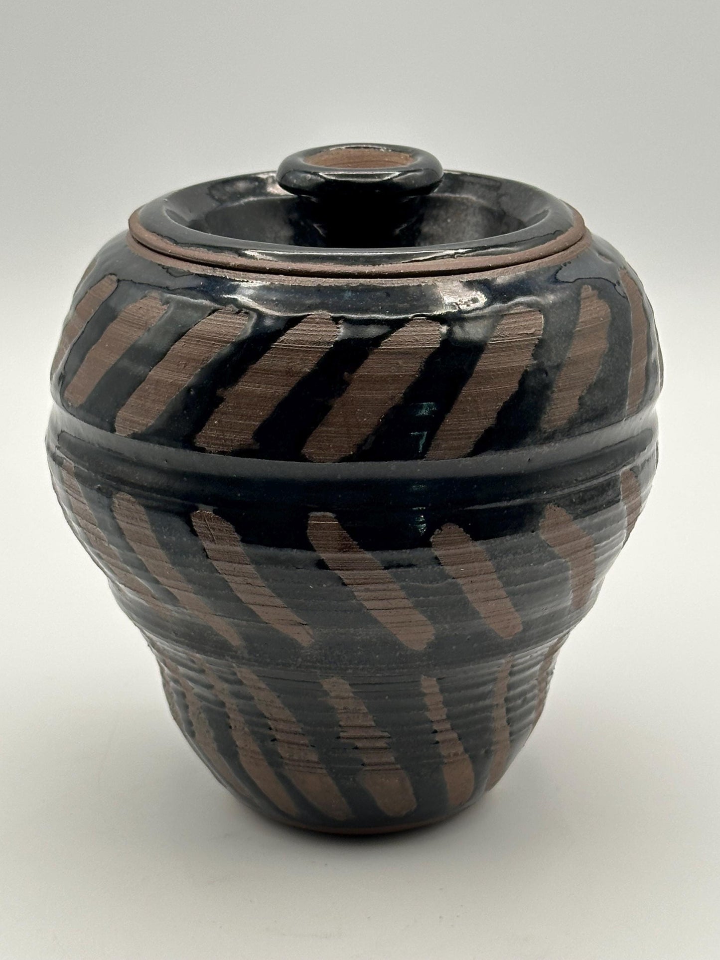 Artisan-Signed Rustic Stoneware Jar: Brown & Black Striped Pottery Vessel with Lid